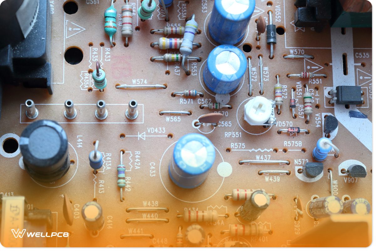 A brown PCB with through-holes that hold several components