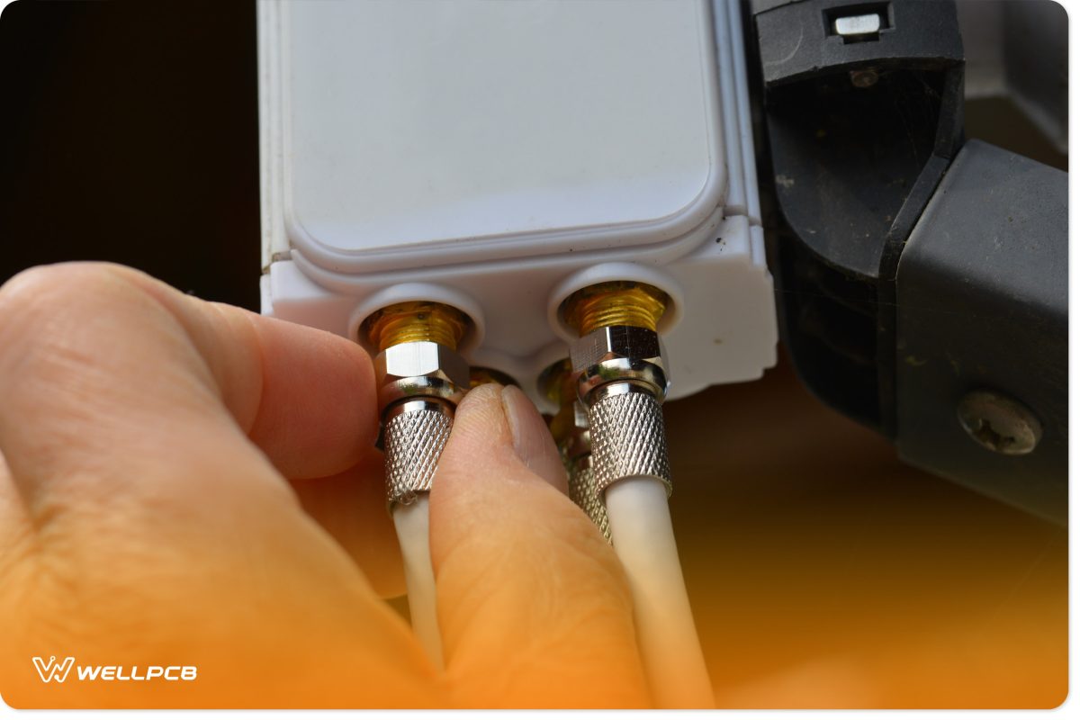 A man plugging a coaxial cable