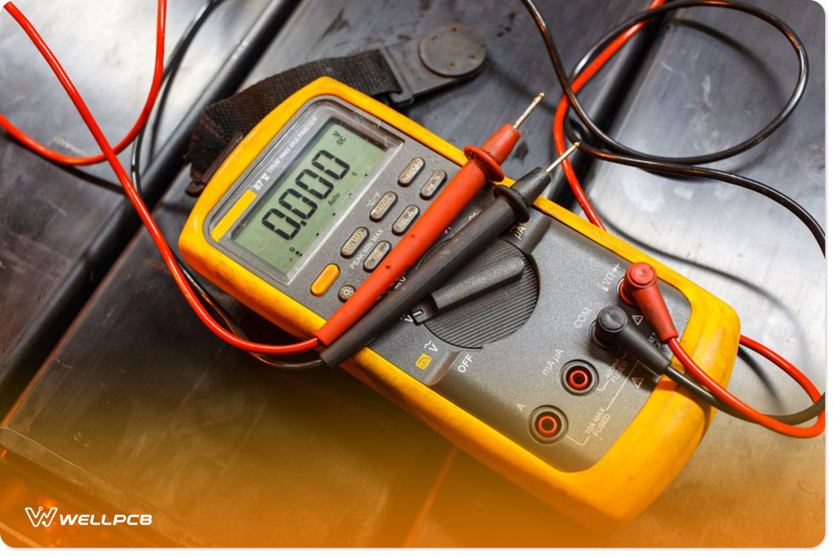 A multimeter tests the battery