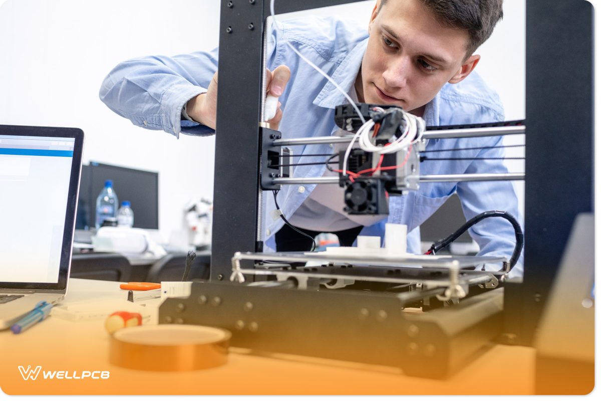 A student setting up a 3D printer by leveling the bed