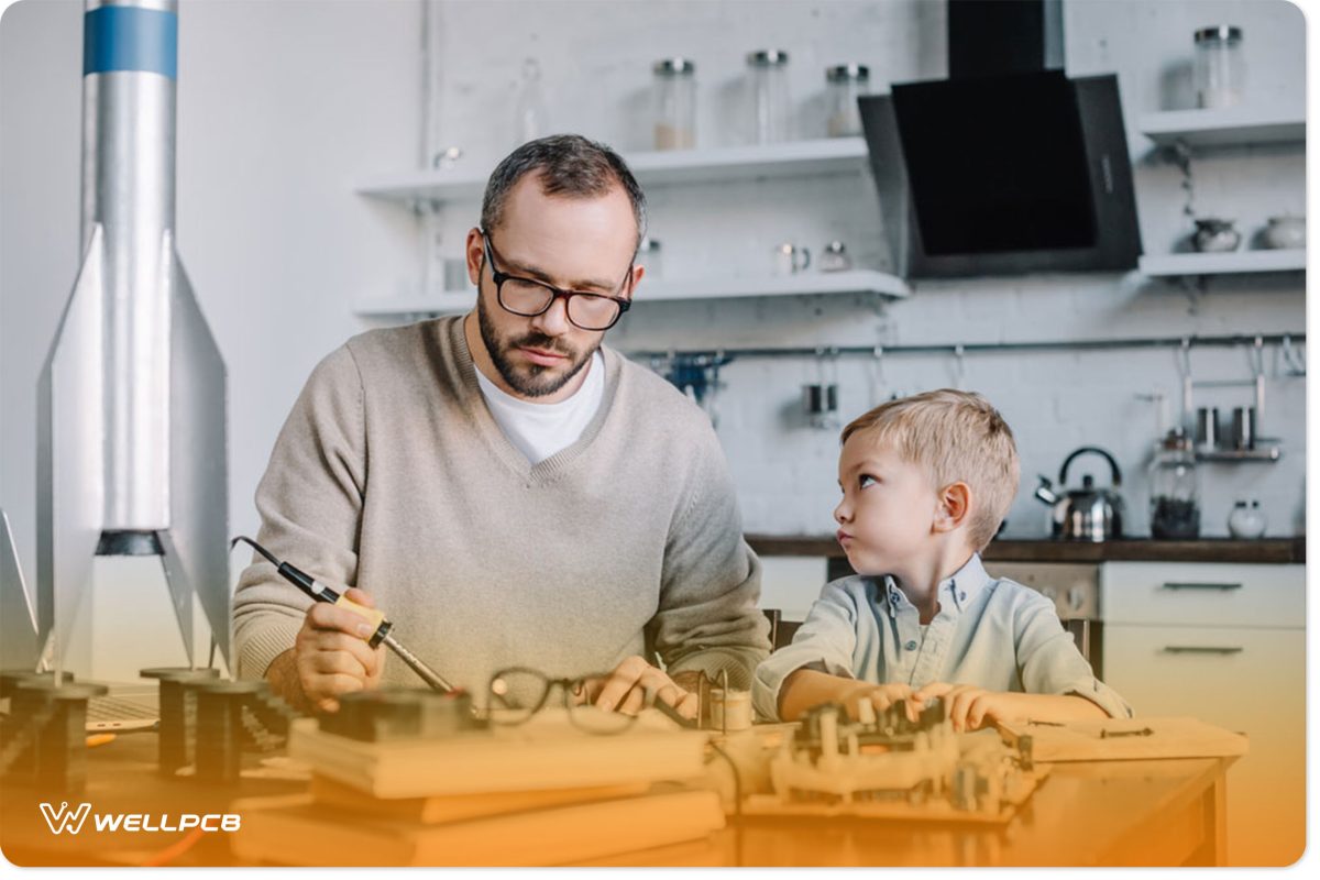 Father and son soldering a circuit board