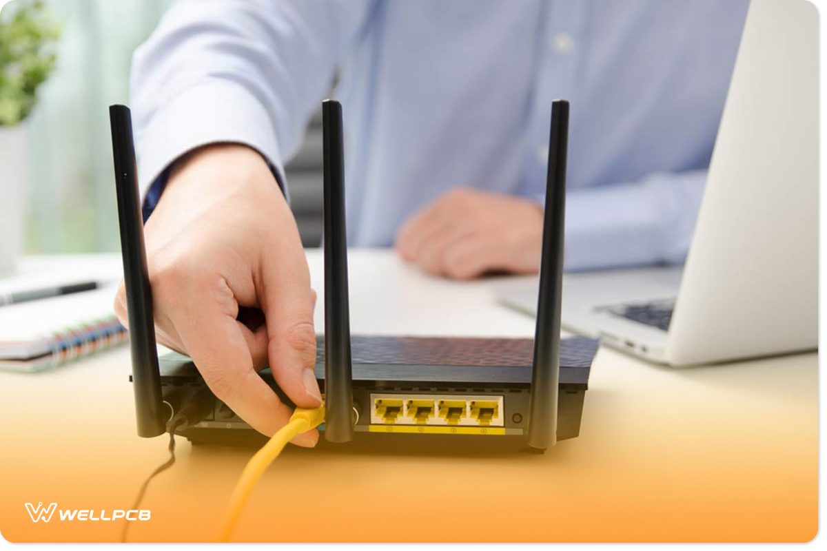 Man plugging ethernet cable to a router