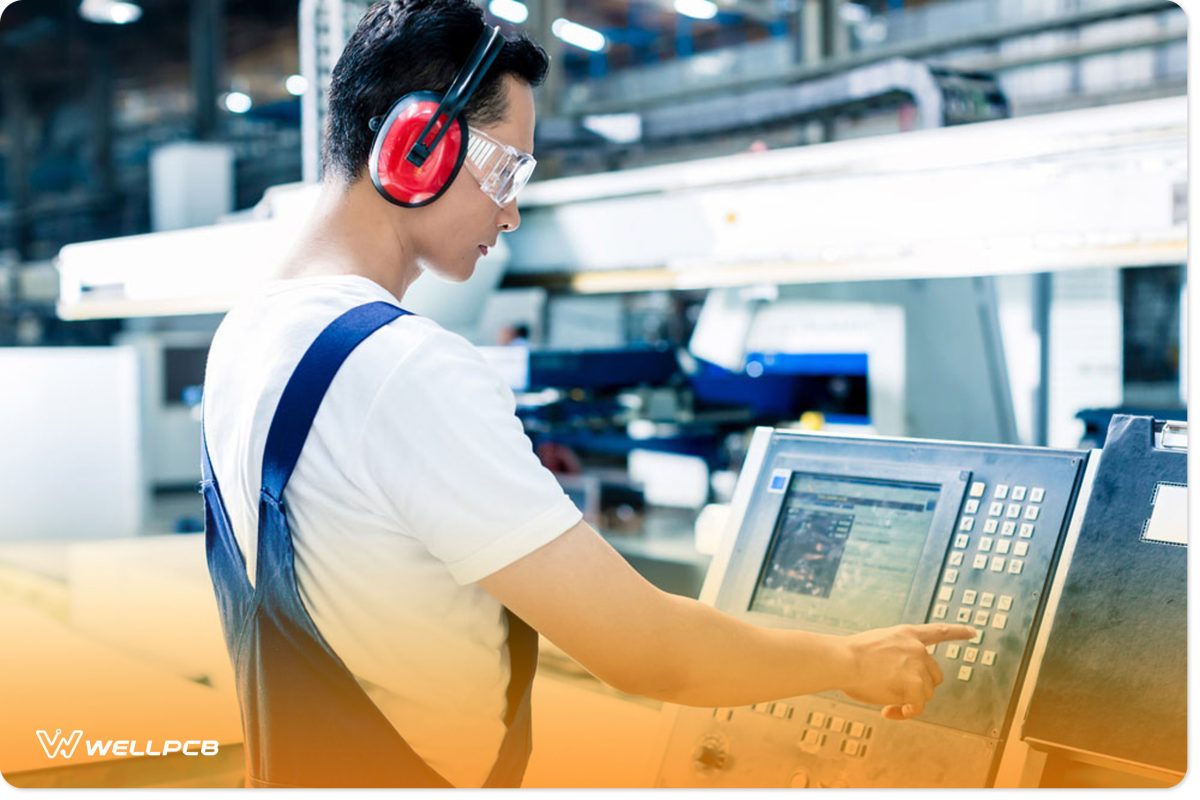 Worker Entering Data into a CNC Machine