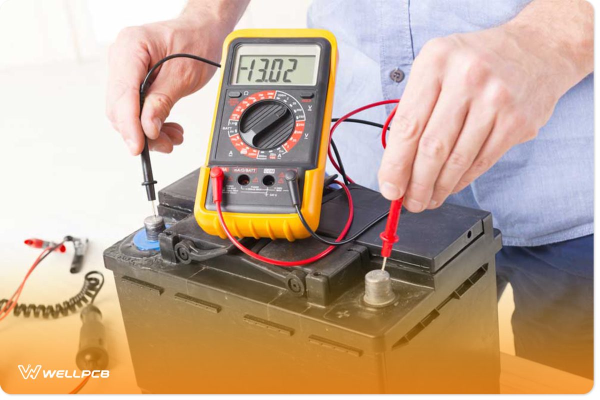 a digital voltmeter measuring the voltage of a battery